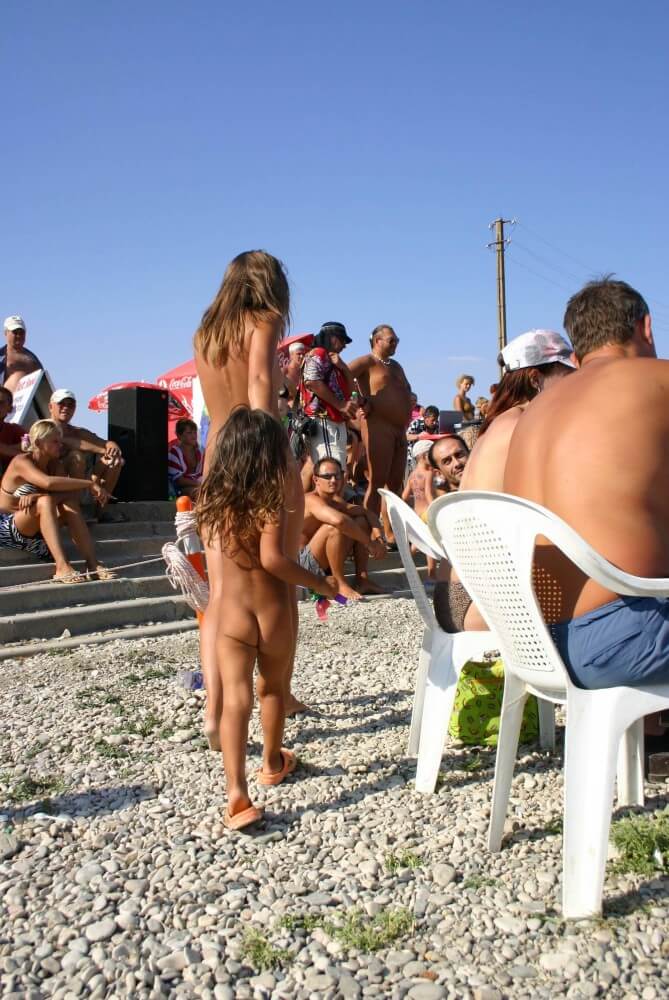 Naturist Standing Sideline - The equality of naked human bodies helps us accept ourselves and others