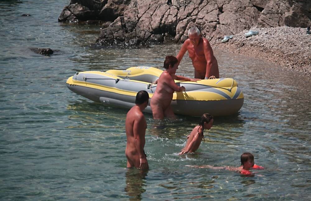 Lone Nudist in Yellow Boat photos - Types of recreation in nudist and naturist resorts and parks
