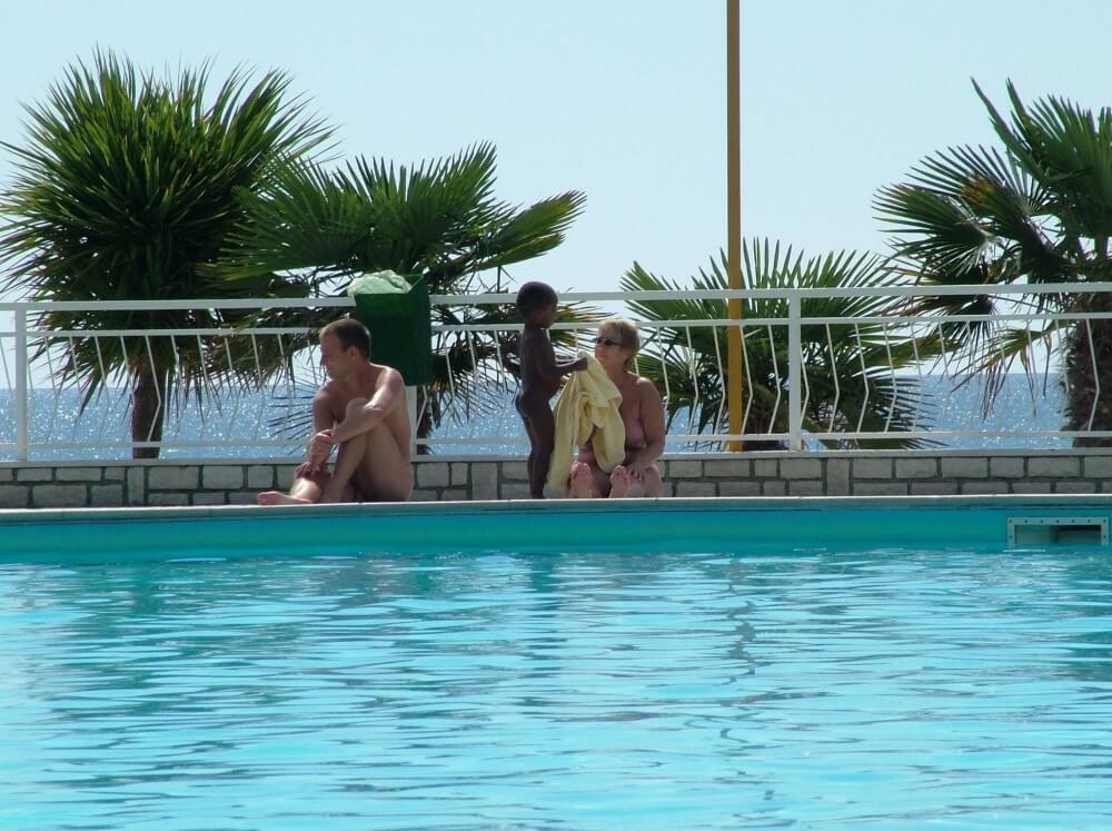 Photo of naturists in an outdoor pool - Naturism and Environmental Awareness